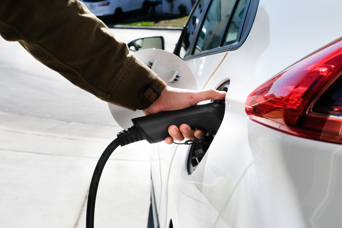 EV charger being plugged into car